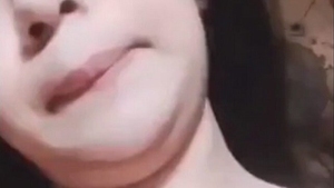 A stunning young woman showcases her smooth vagina and large buttocks