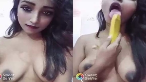 A shy single girl pleases herself with a banana in a nude video