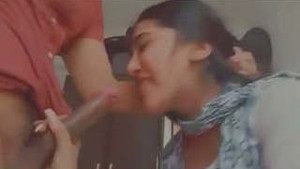 A young Indian college student performs oral sex on two large penises in an explicit video