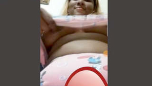 Watch a stunning girlfriend flaunt her ample bosom in a video call