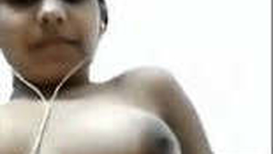 A college girl with perky breasts indulges in self-pleasure during a video call