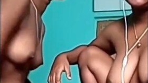 Two Indian lesbians with large breasts engage in oral sex