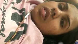 Young woman flaunts her breasts during a video call
