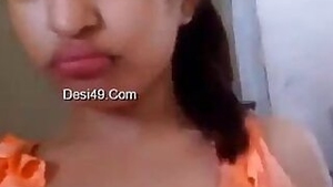 Indian babe in orange takes clothes off to flaunt boobs and buttocks