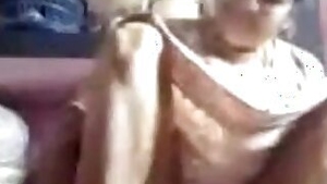 Arousing Desi mom sits on floor and denudes snatch under the dress