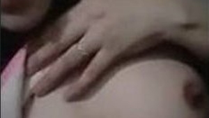 A Pakistani girl seductively displays her ample bosom
