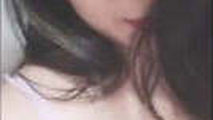 A stunning woman flaunts her large breasts and tight vagina