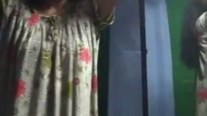 Tamil girl with a slender figure changes her clothes in a village