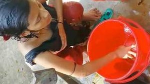 Village girl from India bathes in the open air