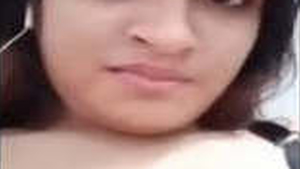 A seductive Indian woman of South Asian descent reveals her pale breasts and intimate area