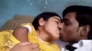 A passionate Desi couple smooching and pressing on their breasts