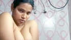 A young wife with large breasts films a video for her husband in the bathroom